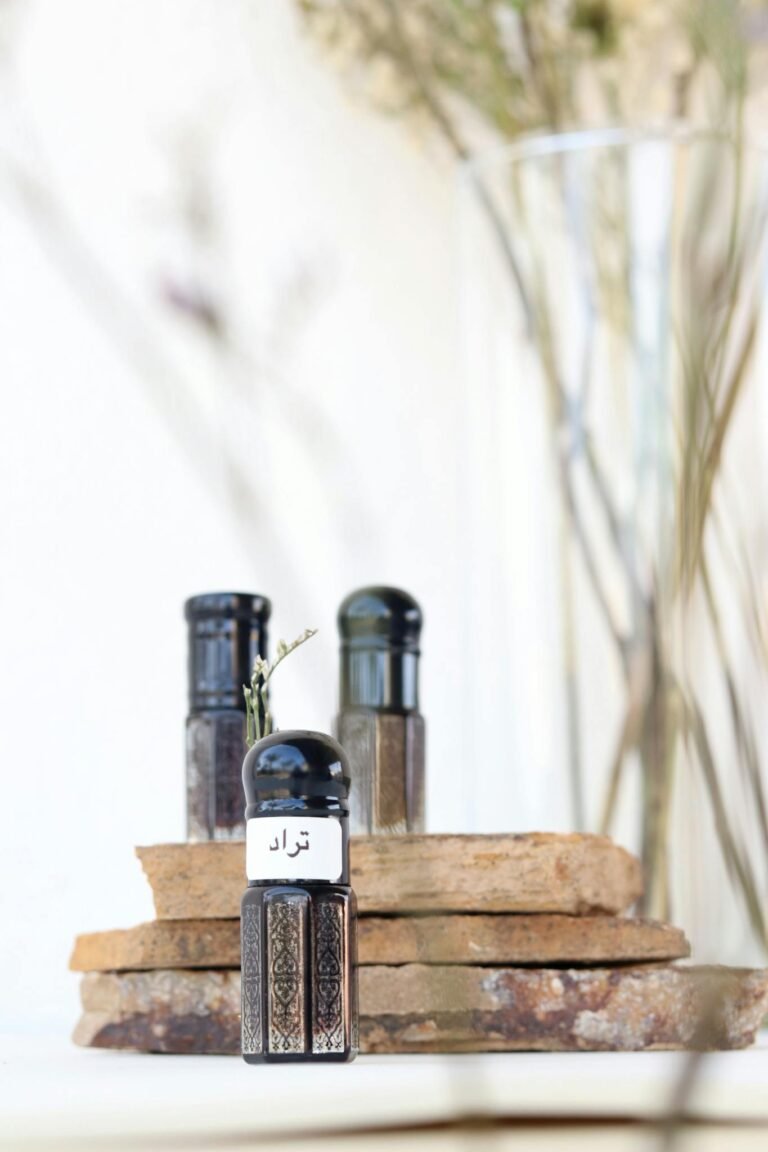 Elegant display of traditional Omani perfume bottles with intricate designs and natural elements.