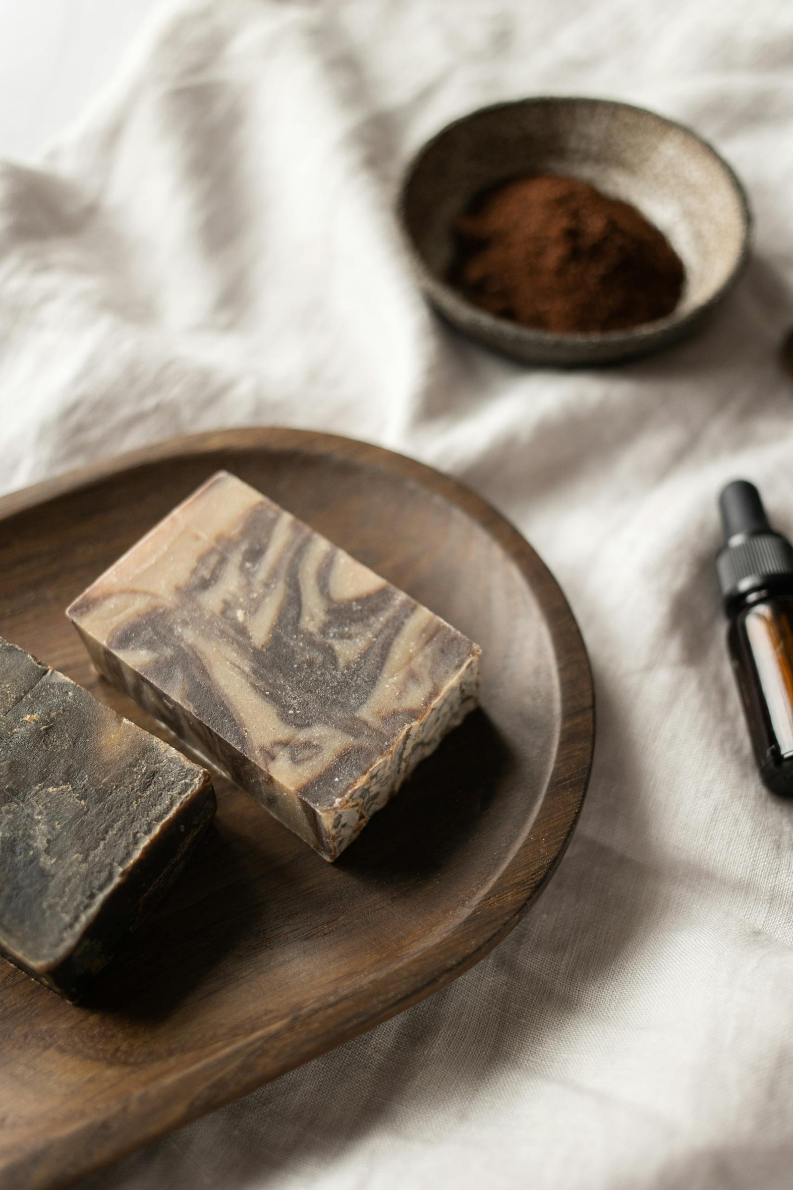 Organic handmade soap with aromatic oils on a wooden tray, perfect for a spa-like skincare routine.